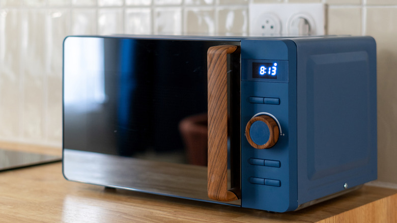 blue and wood grain microwave on a wood counter