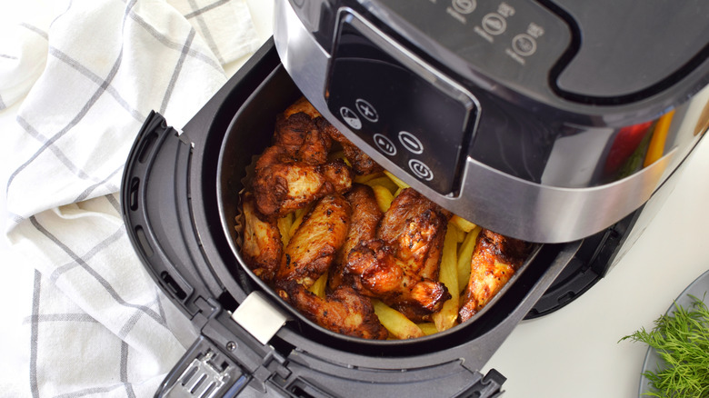 crispy chicken wings inside an air fryer basket