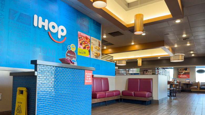 Host station and waiting area inside IHOP restaurant.