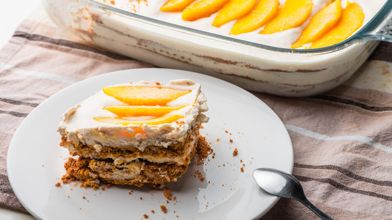 A slice of frozen mango float icebox cake on a plate.