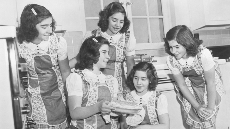 black and white pic of young girls holding a pie
