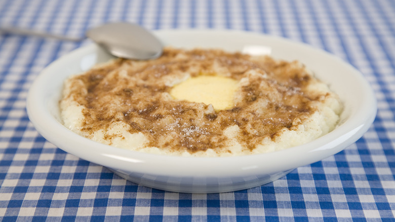 A bowl of hot wheat cereal in a blue checkered table cloth