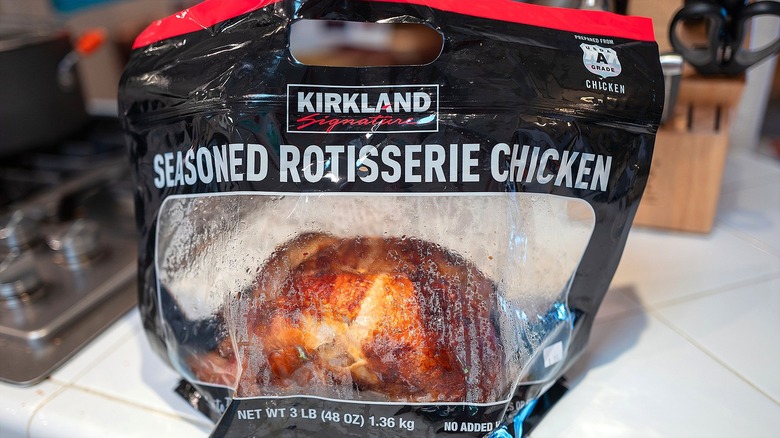 One bagged Costco Kirkland Signature's Seasoned Rotisserie Chicken on a kitchen counter