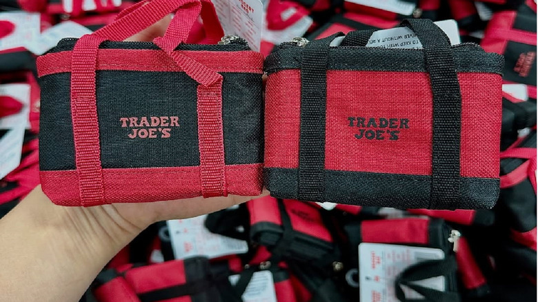 Two Trader Joe's micro totes being held