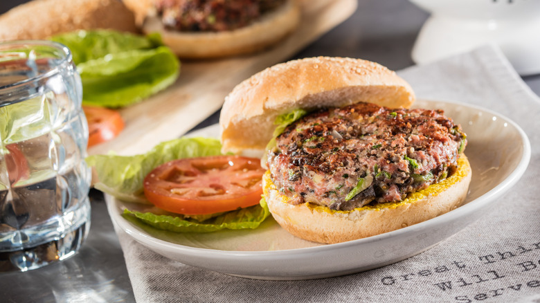 A turkey burger with lettuce and tomato on a lunch plate