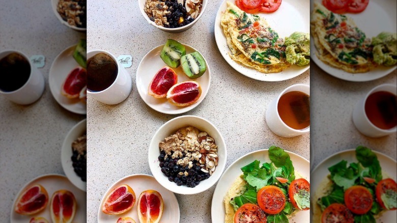 Breakfast spread, including acai bowls, fruit, omelets, and coffee, at a UCLA dining hall