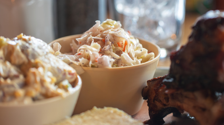 coleslaw in a restaurant next to some out of shot ribs