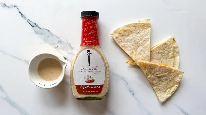 top down view of Skinny Girl chipotle ranch bottle with saucer and quesadilla slices