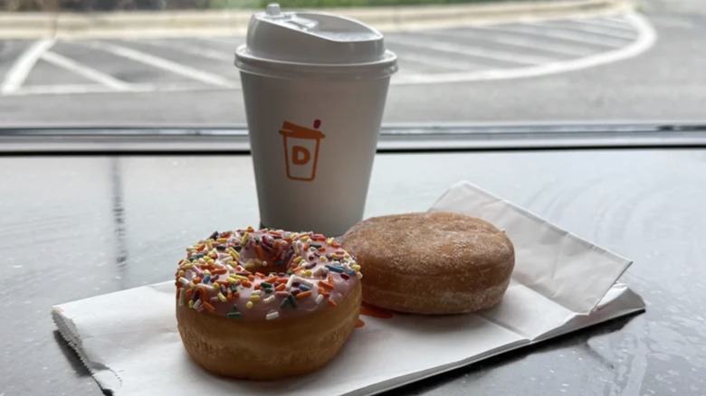 two dunkin' donuts and a cup of coffee