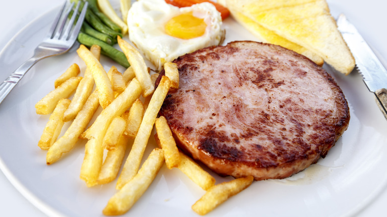 Ham steak on plate