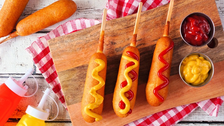 Corn dogs on wooden board