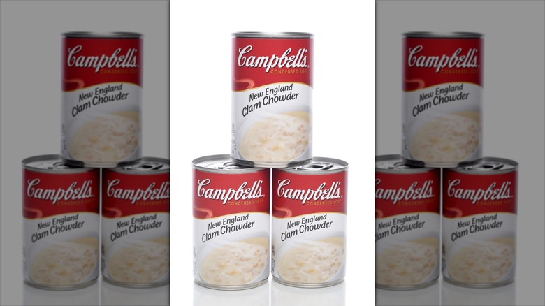 Three Campbell's Condensed New England Clam Chowder cans stacked against a white background