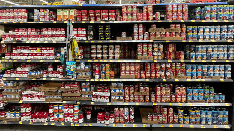 Grocery store shelves filled with different canned soups