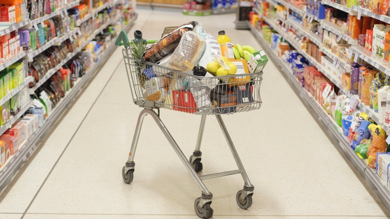 Shopping cart filled with groceries in supermarket