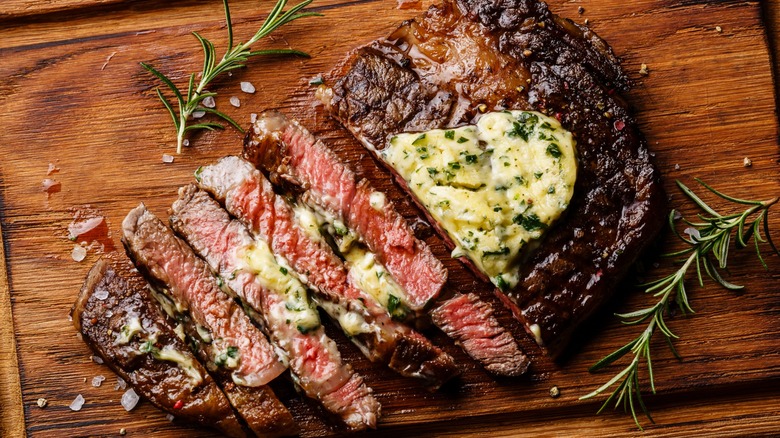 A grilled ribeye steak with herb butter