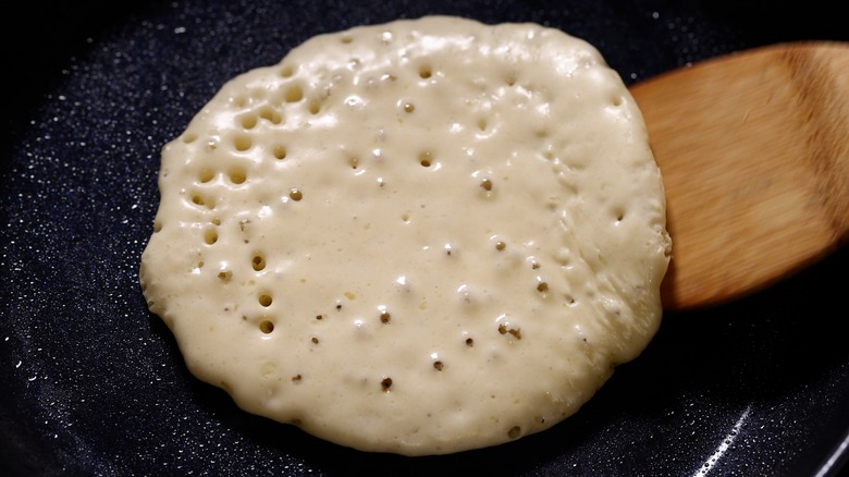 spatula flipping bubbly pancake batter