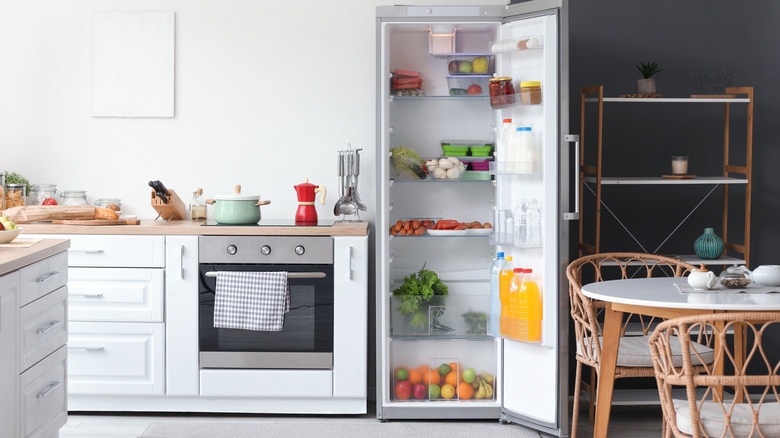 Neatly organized kitchen with open fridge