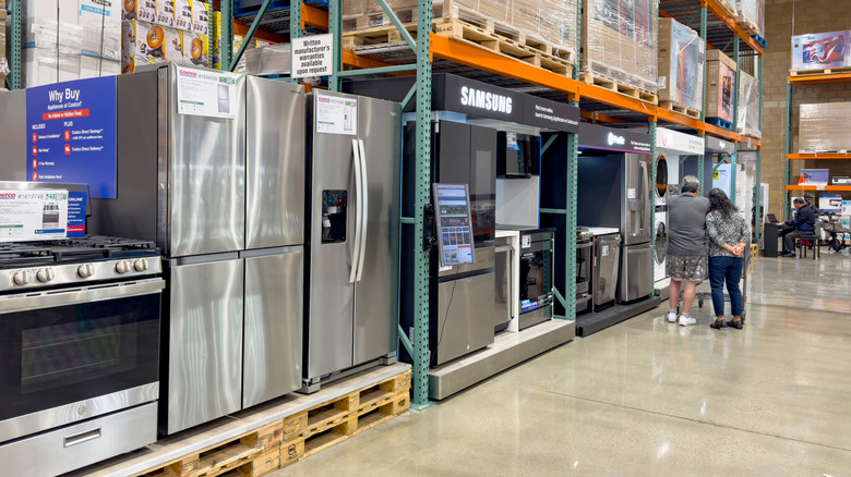 Couple shopping for kitchen appliances at Costco