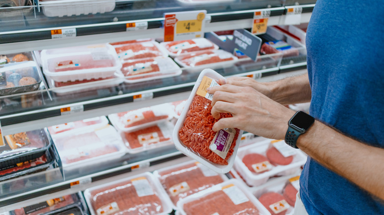 Person holding a package of ground beef