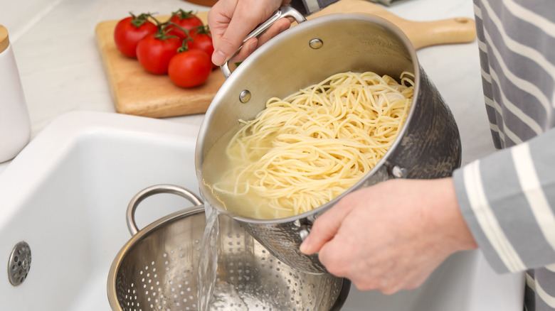 straining pasta in sink