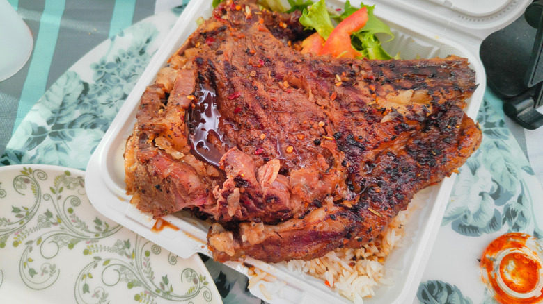 steak displayed in takeout container