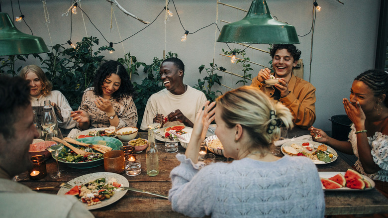Friends gathered around a table at a dinner party