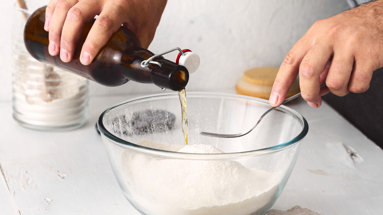 cook adding beer into batter