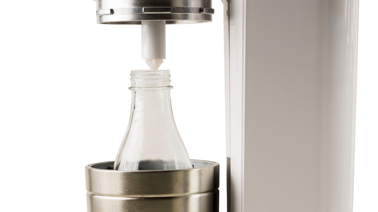 A close up of a SodaStream nozzle on a white background.