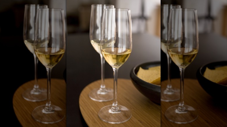 Two Champagne flutes containing tequila