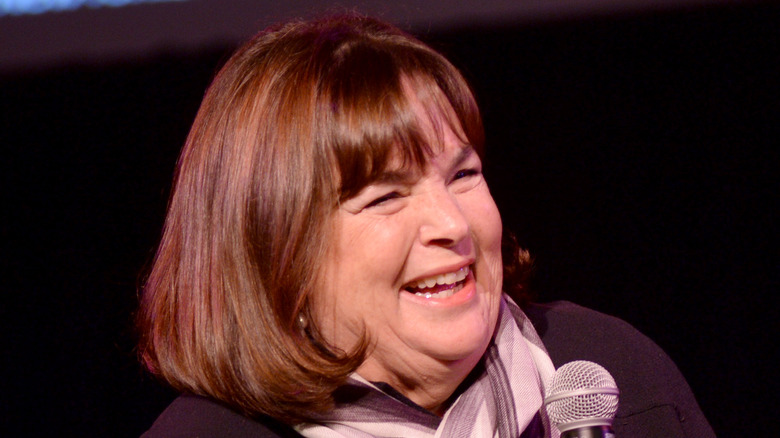 Ina Garten smiling and holding a microphone