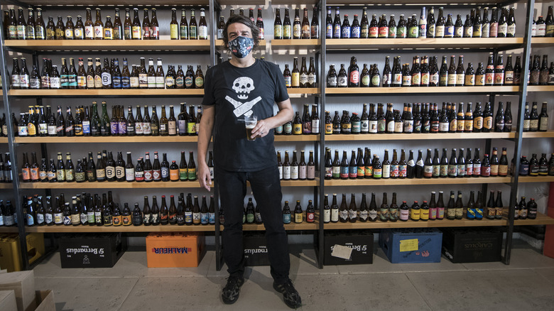 vendor in front of craft beer bottles