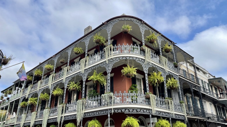 A corner building with wraparound balconies on New Orleans' Bourbon Street.