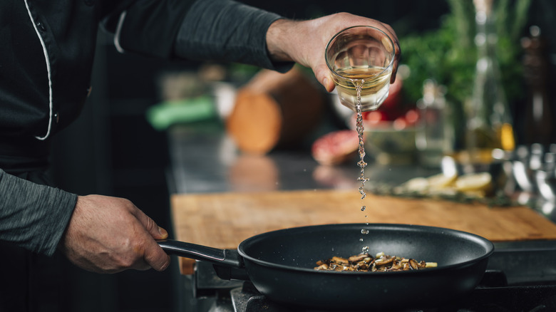 Pouring wine into a pan