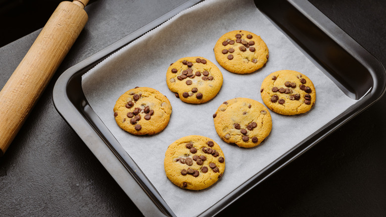 Pan of chocolate chip cookies lined with parchment paper