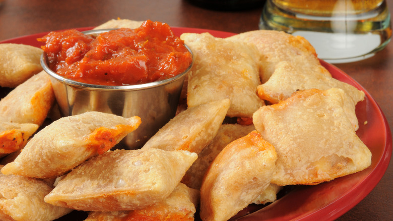 a plate of cooked pizza rolls