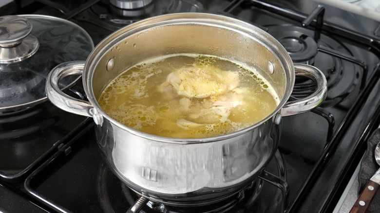 Chicken boiling in a metal pot