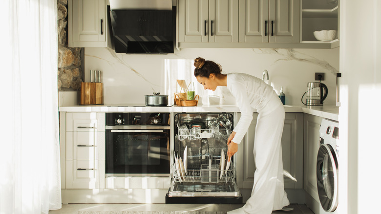 Woman washing dishes in a kitchen