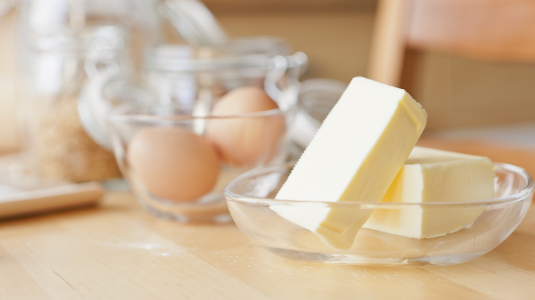 Sticks of butter and eggs to be used for baking cookies