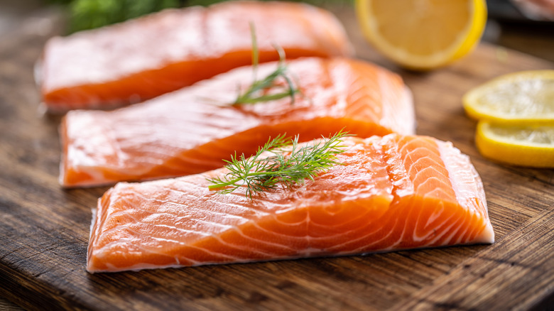 Salmon fillets on wooden plank