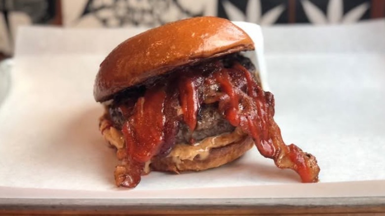 The Dee Snider burger has bacon hanging out of it