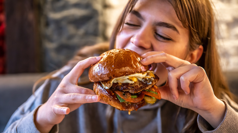 Girl eating hamburger