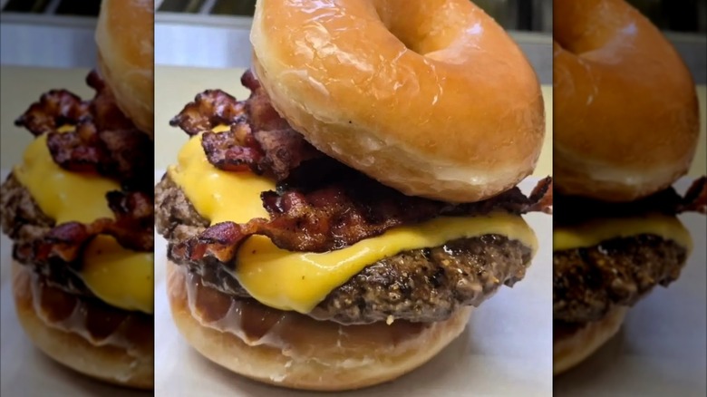 A beef patty, cheese slice, and bacon between two glazed donuts