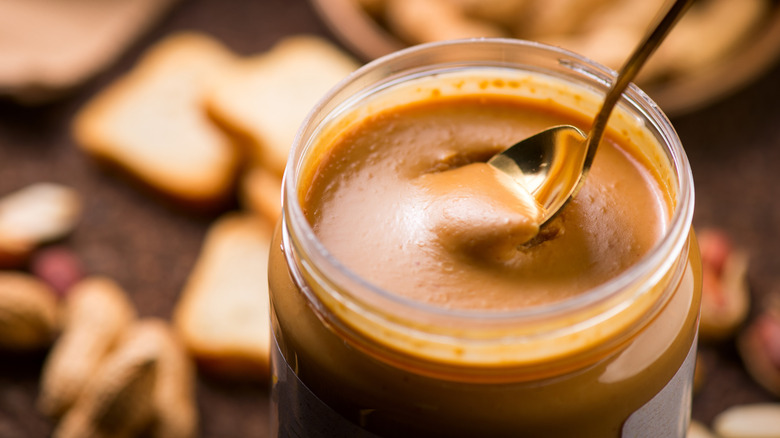 Jar of peanut butter with spoon in it