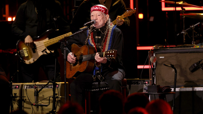 Willie Nelson playing guitar