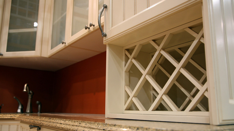 Wine rack attached to a cupboard in a kitchen