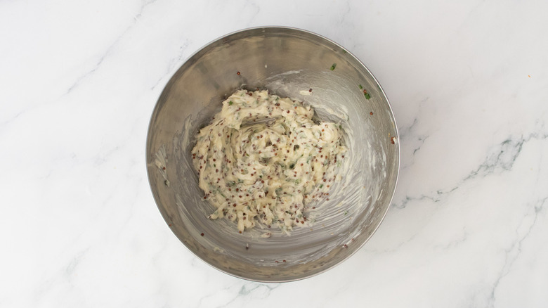 Herby compound butter in a medium metal bowl