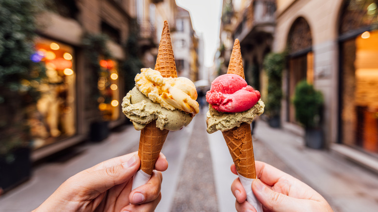 Two people holding ice cream cones.