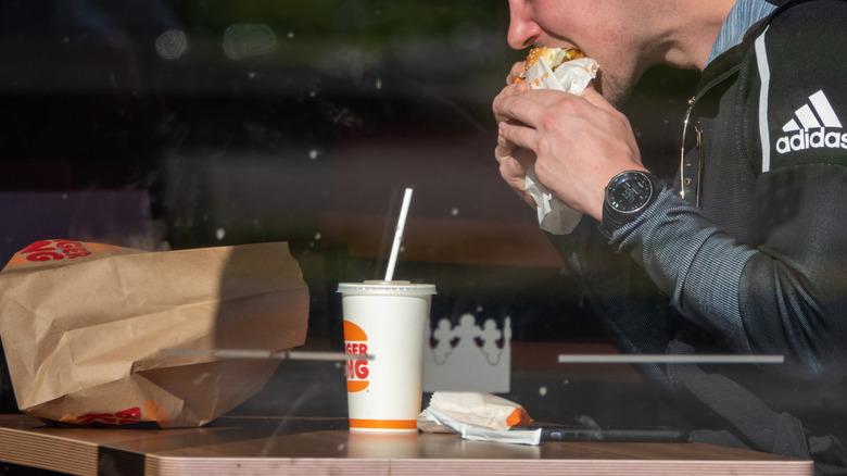 Customer eats a sandwich at Burger King
