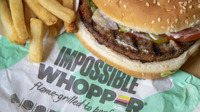 Impossible Whopper and fries sit on top of an Impossible Whopper wrapper