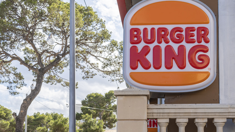 Outdoor Burger King sign is positioned next to trees